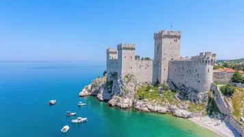 historic fortress overlooking sea with massive stone walls and beautiful blue waters photo