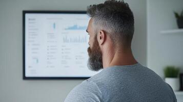 Confident man analyzing data on screen, showcasing business insights and trends photo