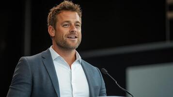 Confident speaker presenting at business event, engaging audience with enthusiasm photo