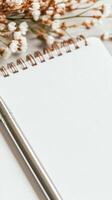 Minimalist stationery with silver pen and open notebook on a rustic wooden table flat lay photo