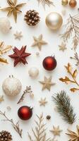 Festive christmas ornaments arranged on white background with stars, pinecones, and baubles in red and gold photo