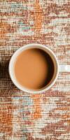 Cozy Top View of Coffee Mug on Textured Fabric Surface with Warm Tones photo
