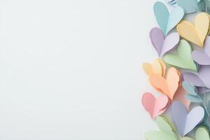 Colorful paper hearts arranged on white background, showcasing creative art design and pastel aesthetics photo