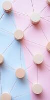 Minimalist pink and blue background with wooden circles connected by strings showcasing abstract network concept photo