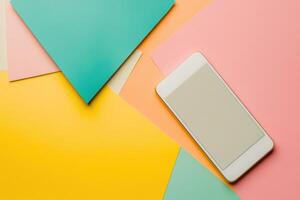 Smartphone on vibrant geometric background with pastel abstract shapes photo
