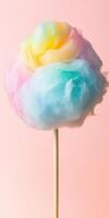 Multicolored cotton candy on stick with pastel background showcasing sweetness and soft textures photo