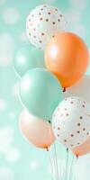 Cluster of colorful balloons with polka dots against pastel blue background for festive celebration atmosphere photo