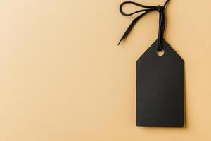 Minimalist black tag on a beige background with string, simplicity in design and elegance in presentation photo