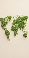 Green world map created with leaves on a light background symbolizing environmental awareness photo