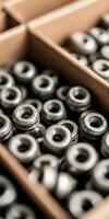 Closeup of metallic industrial components in organized storage containers for manufacturing process photo