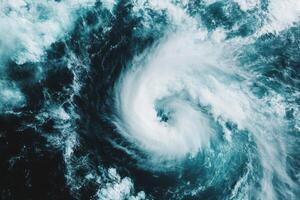 Aerial view of powerful ocean cyclone forming with swirling clouds and turbulent sea, photo