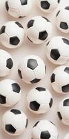 Pattern of black and white soccer balls laid out on a light surface in uniform arrangement photo