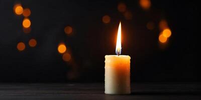 A single candle is lit on a table photo