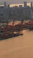 Aerial view of Port of Vancouver, harbour and mountains on the background. Vertical video