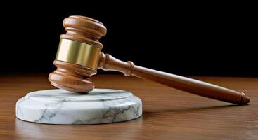 A judge's gavel on a marble stand photo
