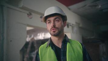 Caucasian man architect contractor guy male executive technician talking walkie talkie connect builder communicate radio set in construction foreman control work employee building process manufactory video