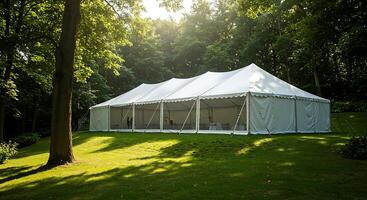 A large white tent in the middle of a field photo