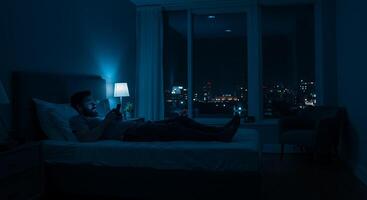 Nighttime Solitude A Man on a Bed City Lights Gleaming photo