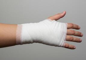Hand Wrapped in Medical Bandage for Injury Recovery and Care photo