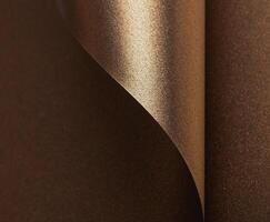 Elegant gold and bronze paper background with a glossy, pearlescent texture. Shimmering metallic photo