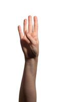 Female hand showing four fingers with the thumb folded, symbolizing the number four or counting. photo