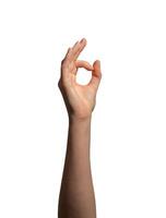 Hand making an OK gesture with thumb and index finger forming a circle, symbolizing approval, photo