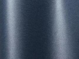 Blue paper background with a smooth, sleek texture and subtle shimmering finish. Rich, cool tones photo