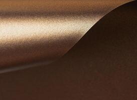 Warm gold and bronze paper background with a glossy, pearlescent texture. Shimmering metallic tones photo