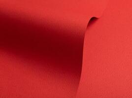 Bright red paper background with a matte texture and rough grain. Vibrant hues create an elegant, photo