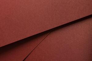 Burgundy paper background with a matte texture and subtle shimmer. Warm, rich tones create an photo