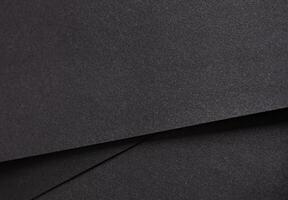 negro papel antecedentes con un texturizado, granoso superficie y sutil geométrico líneas. elegante y foto