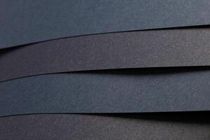 Blue and black striped paper background with a textured finish. Elegant and minimalistic, the photo