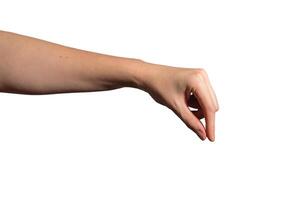 Female hand pinching small invisible object, delicate grip gesture with thumb and index finger. Sign photo