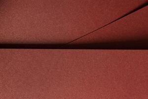 Burgundy paper background with a smooth texture and a metallic, glossy finish. Rich, warm tones photo