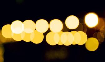Warm, blurry background with soft focus circles of yellow and orange light, creating a cozy, festive photo