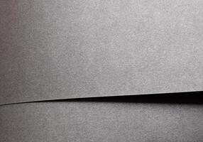Gray metallic paper background with a pearlescent, glossy texture. Silver tones and a satin finish photo
