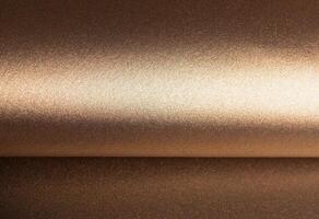 Warm gold and bronze paper background with a pearlescent, metallic texture and shimmering effect. photo