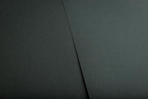 Deep green paper background with a textured, rough surface. Elegant and natural tones create a photo