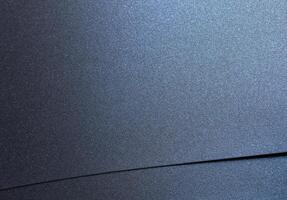 Navy blue paper background with a smooth, glossy texture and a pearlescent finish. Deep, rich tones photo