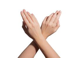 Hand with neatly groomed short nails crossing fingers in an elegant gesture. Glossy, soft skin with photo