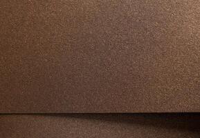 Warm gold and bronze paper background with a pearlescent, metallic texture and subtle shimmer. The photo