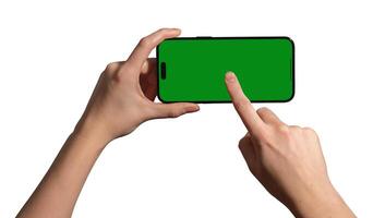 Hand holding a smartphone horizontally with a blank green chromakey screen, index finger tapping the photo
