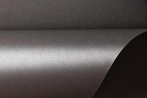 Gray metallic paper background with a pearlescent, glossy texture. Subtle silver tones create an photo