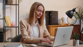Inefficient tired lazy business woman working sleeping on laptop computer with eyes stickers on face video