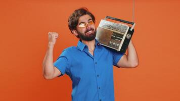Man using retro tape record player to listen music disco dancing of favorite track having fun video