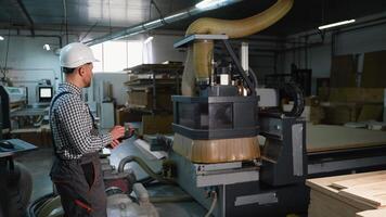 Worker Controls CNC Router Cutting Wooden Panels video