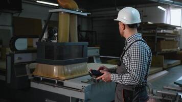 Operator Using CNC Router to Cut Wood Panels video