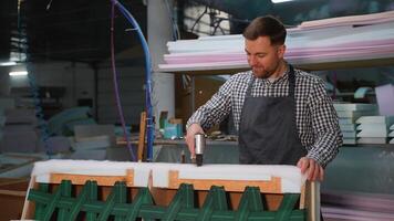 Furniture Maker Stapling Padding on Wooden Sofa Frame video