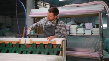 Upholstery Technician Stapling Padding on Sofa Frame video