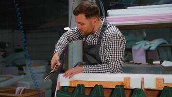 Worker Cutting Sofa Padding During Upholstery Process video